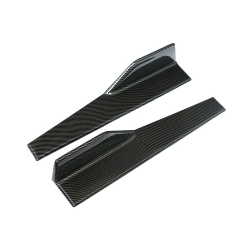 Pair of carbon-look side skirt splitters with winglets on white background