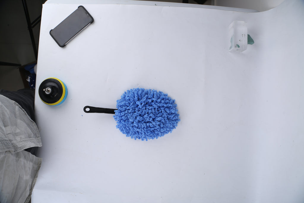 Wash mitt and drill brush attachment on a table